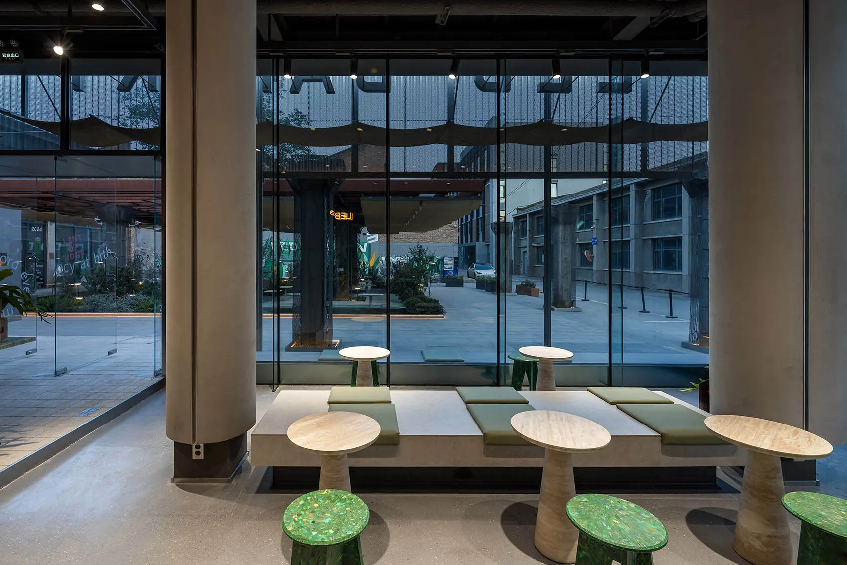 A warm and inviting indoor seating area with multiple wooden tables and chairs, perfect for social gatherings or relaxation