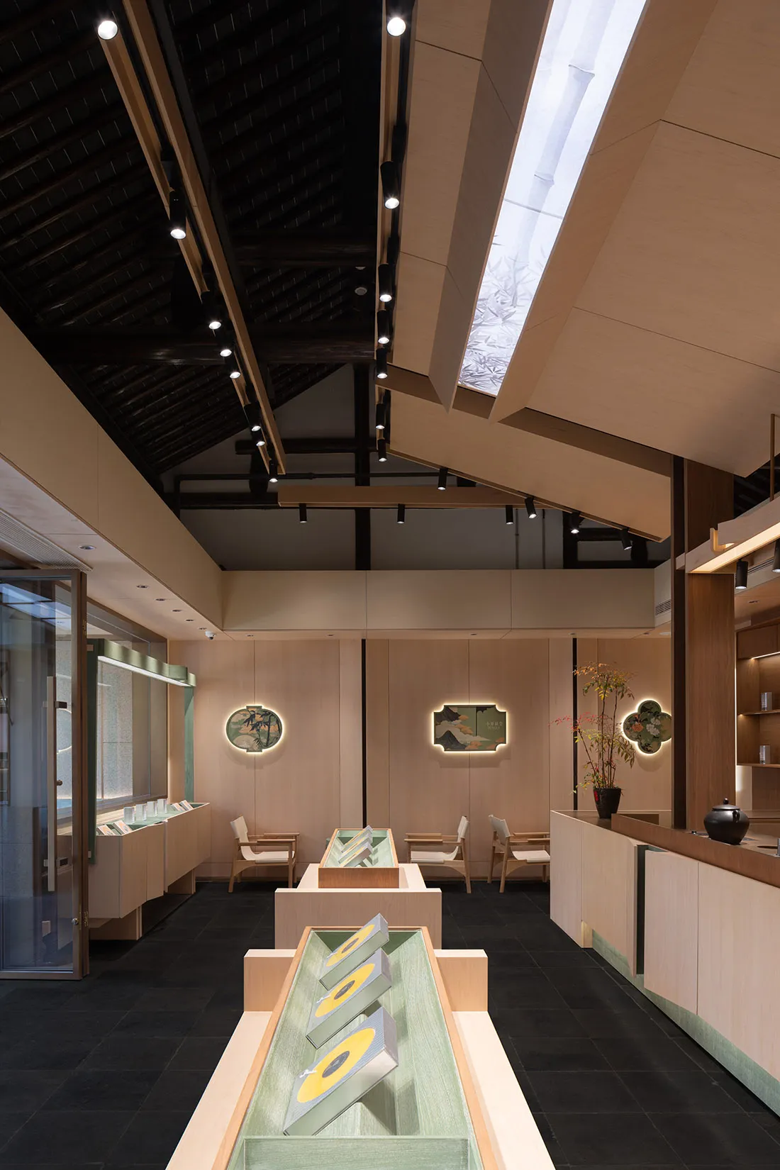 A modern interior design showroom with a large wooden ceiling and walls, featuring chairs and dining tables, with a warm and inviting atmosphere