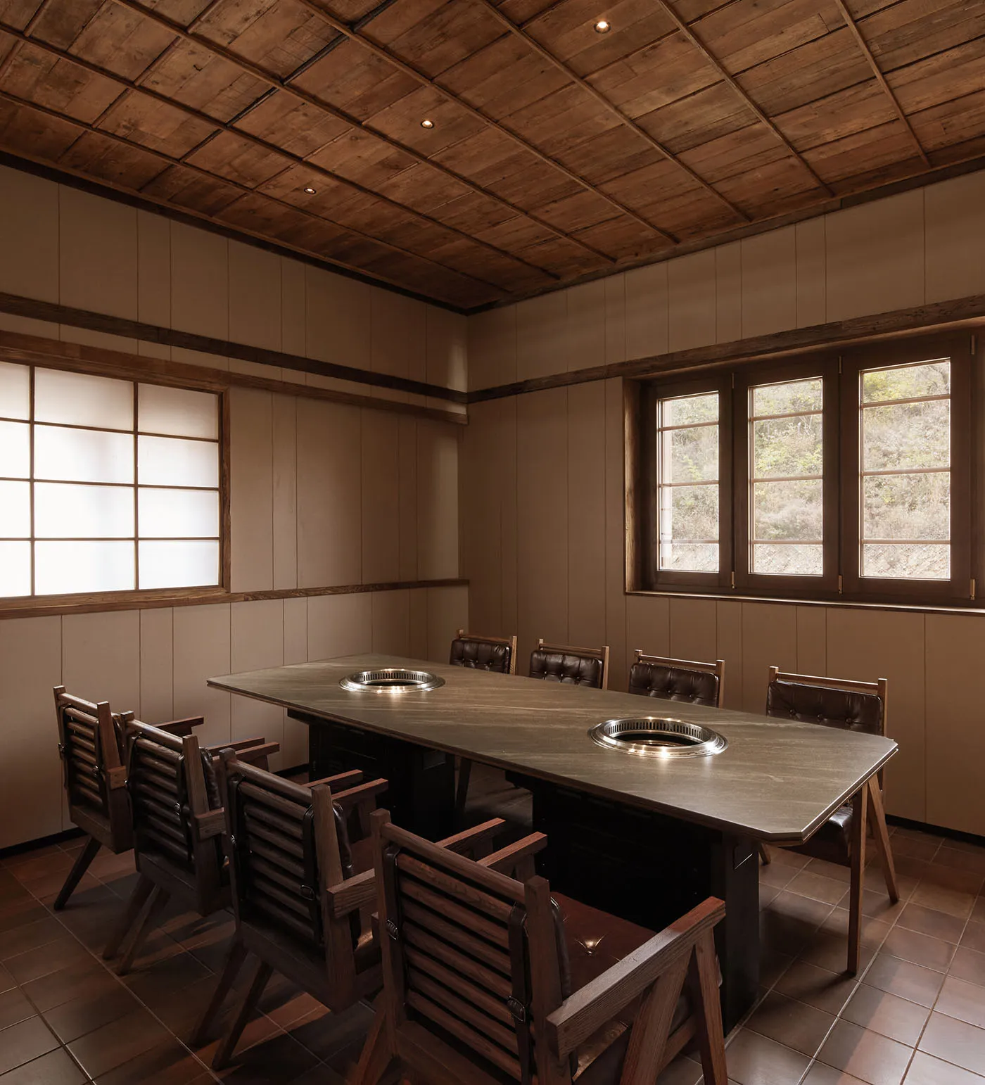 Cozy dining space with a wooden table and chairs, surrounded by warm wood elements and a traditional style