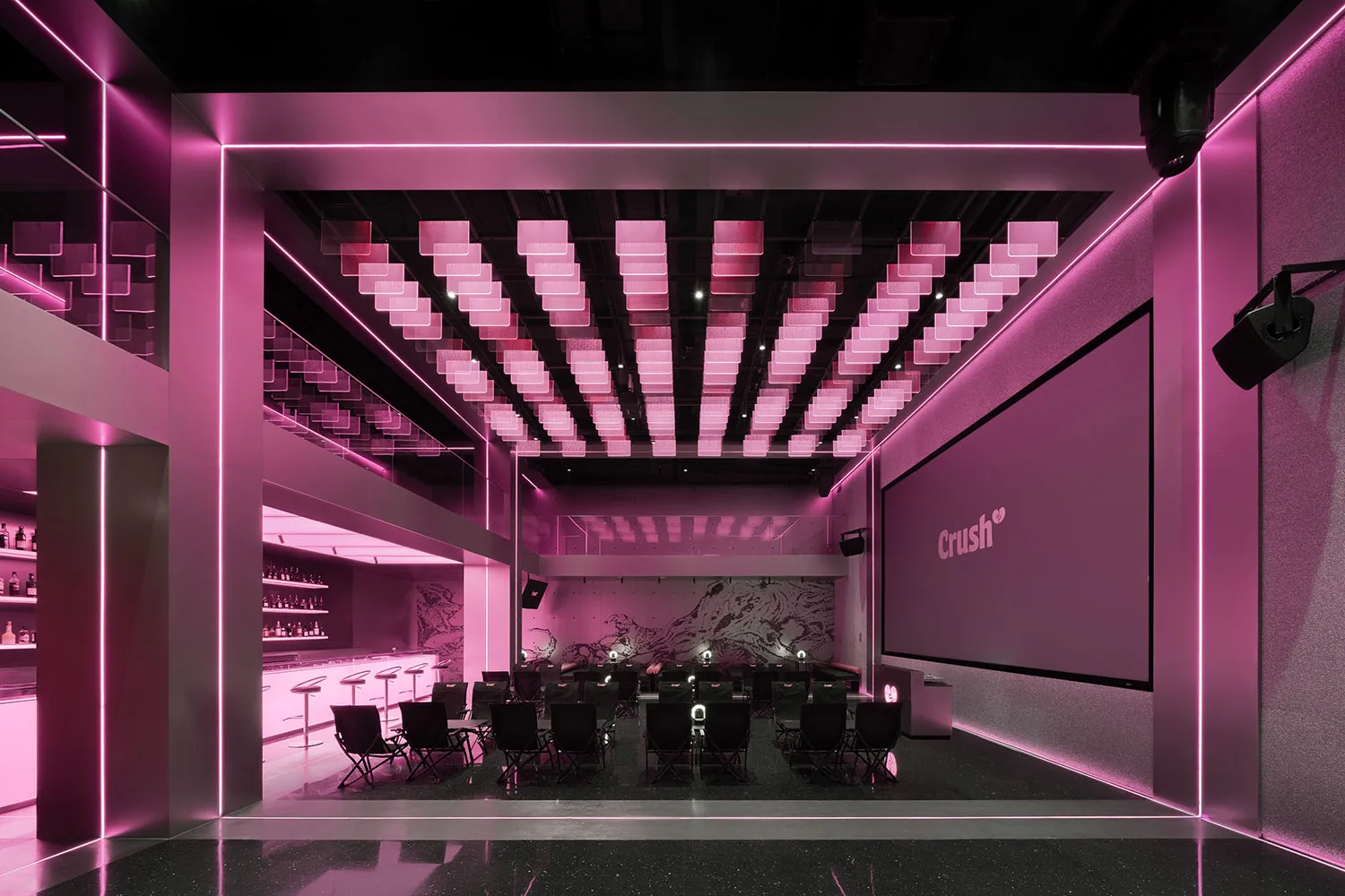 A modern interior design showroom with pink walls, various chairs, dining tables, and decorative bottles, set in a well-lit and inviting space