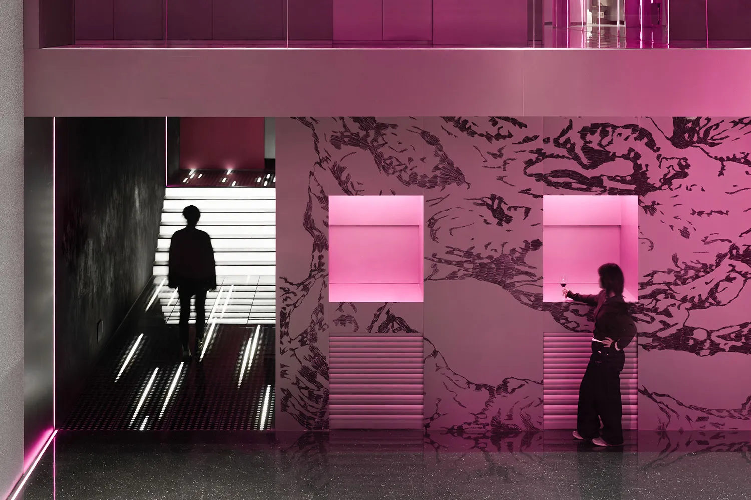 A modern interior space with a staircase, pink and white colors, and bold contrasting elements