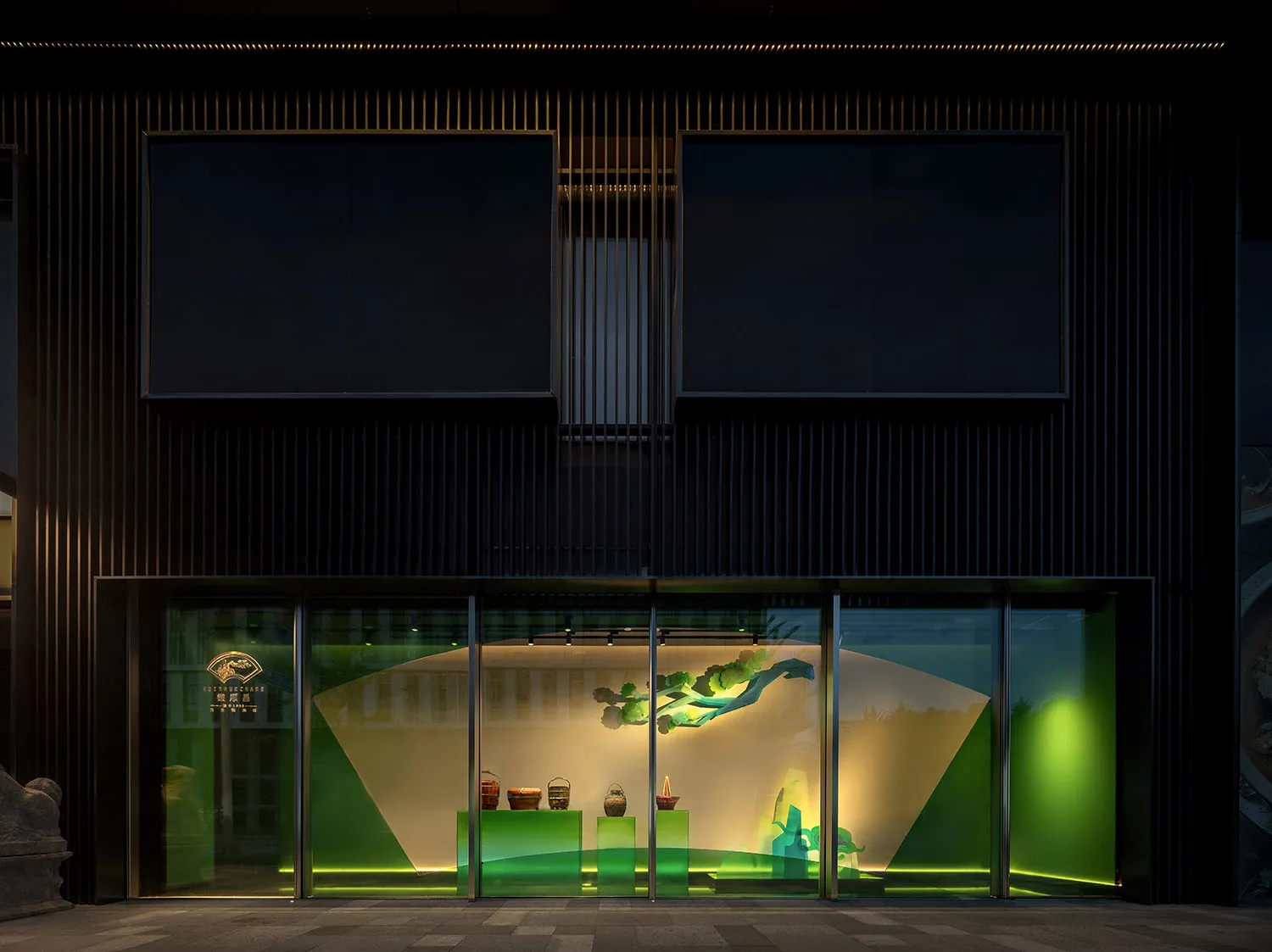 A museum-style interior with sculptures and vases on display, natural light from a large window, and bowls adding to the aesthetic appeal