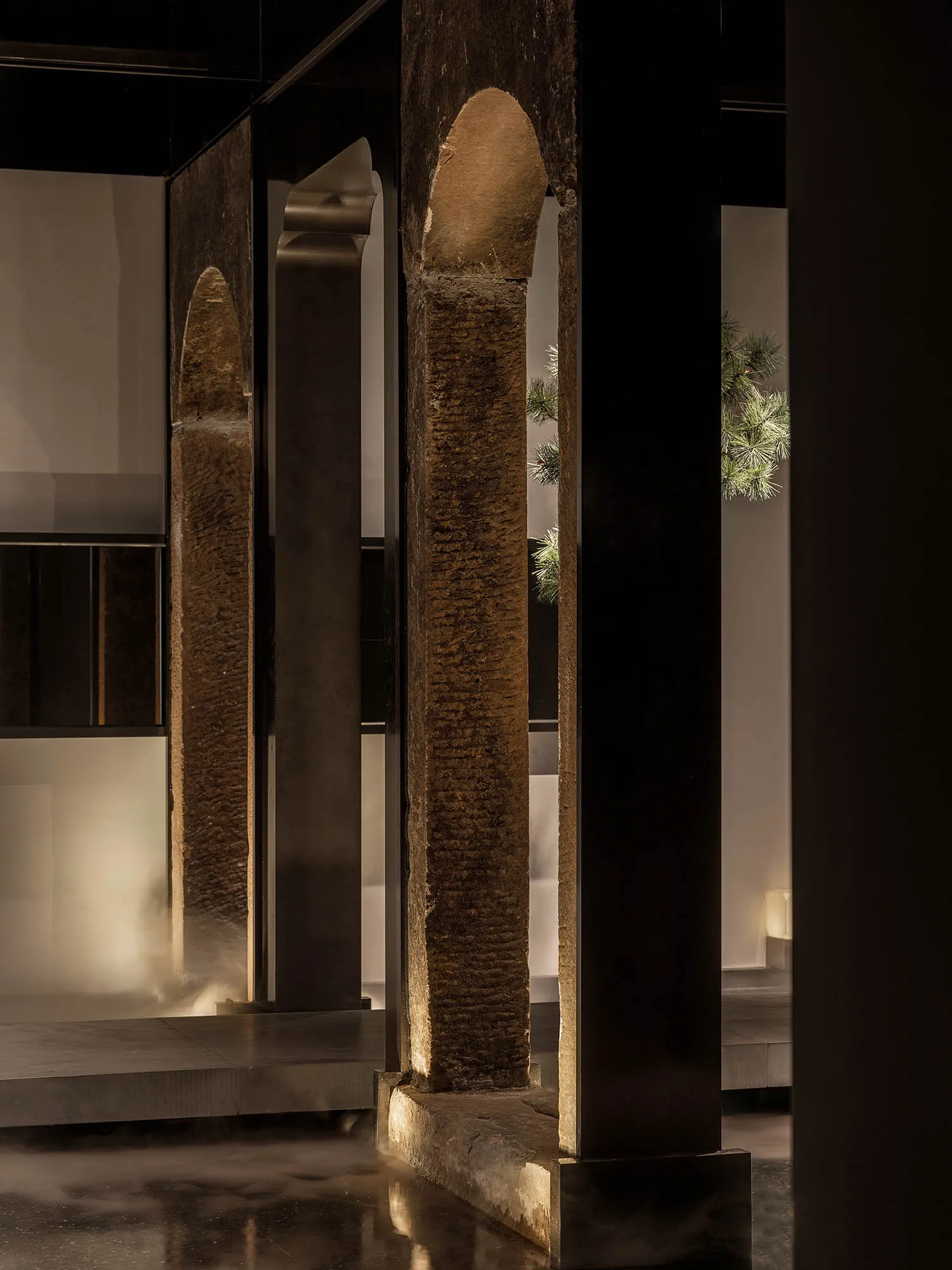 A dimly lit interior space with stone pillars and a mysterious atmosphere, inspired by ancient architecture