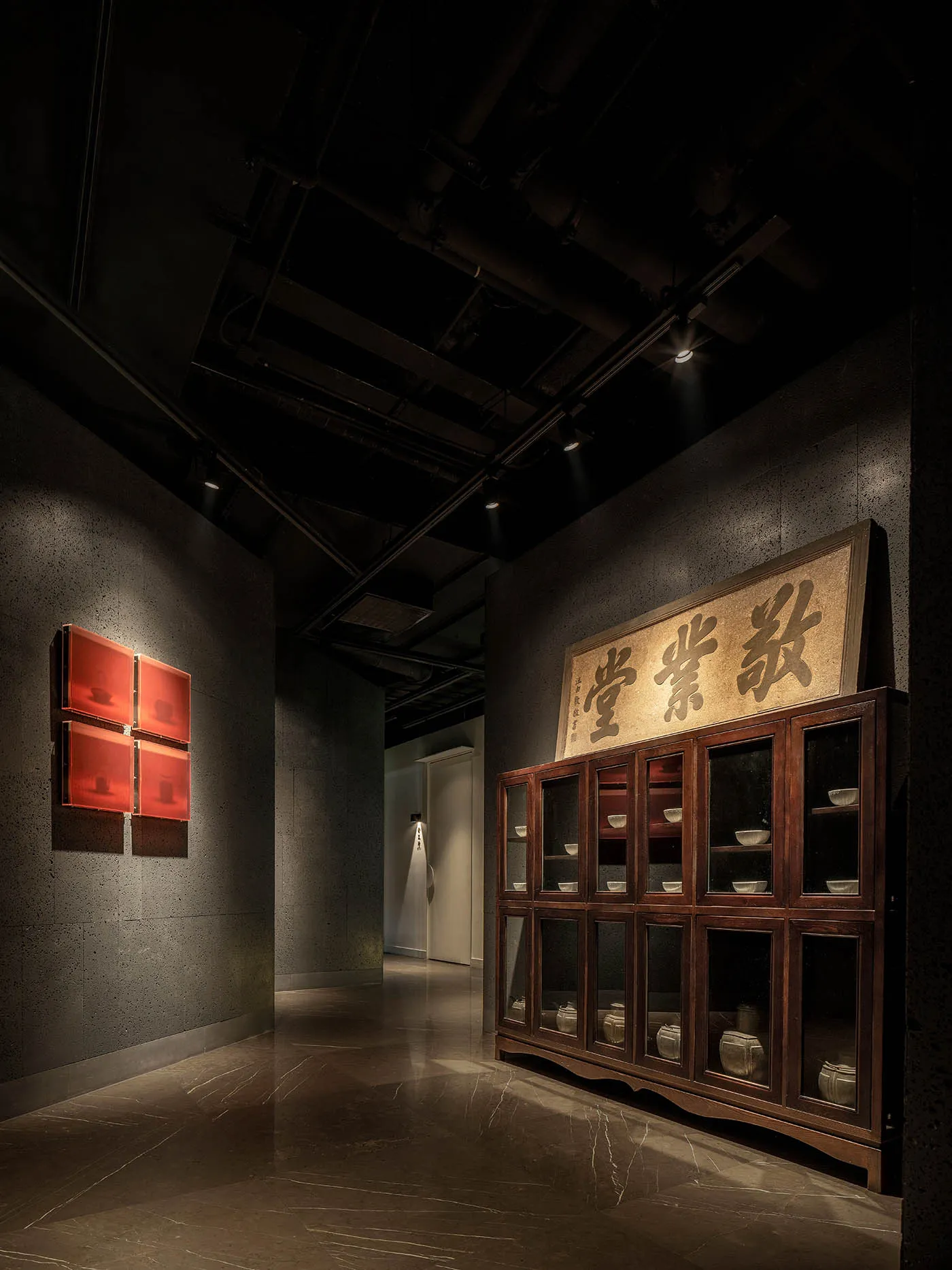 Dimly lit study with a wooden cabinet featuring oriental-style drawers and compartments, surrounded by elegant design elements