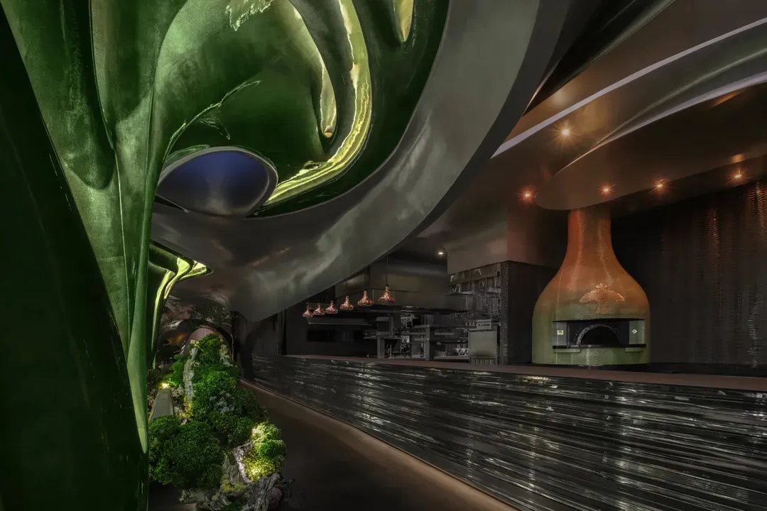 Modern restaurant bar with black marble walls, potted plants, and a countertop