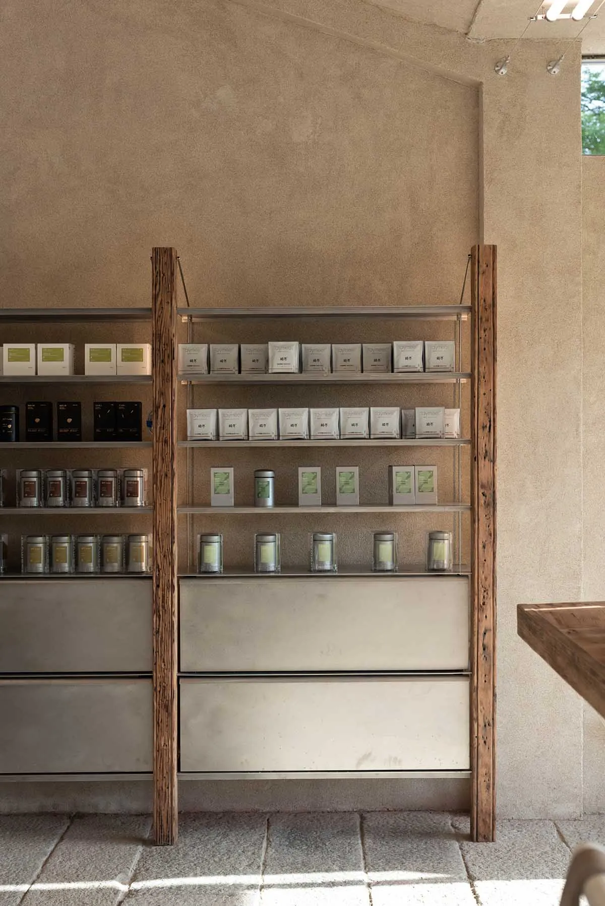 A store display filled with candles, jars, boxes, and bottles, with cups scattered around, creating a visually appealing retail environment