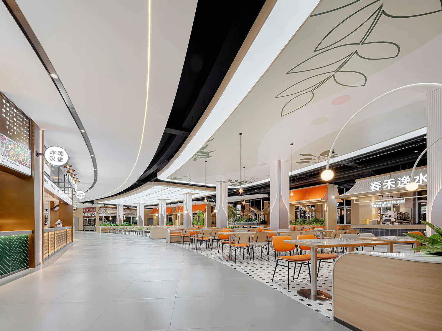 A casual dining area in a shopping mall with multiple tables and chairs, creating a welcoming space for people to eat and socialize