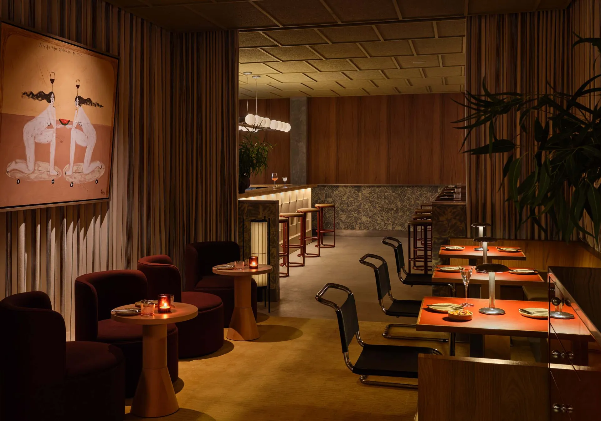 Cozy restaurant with a mix of seating options, potted plants, and comfortable atmosphere