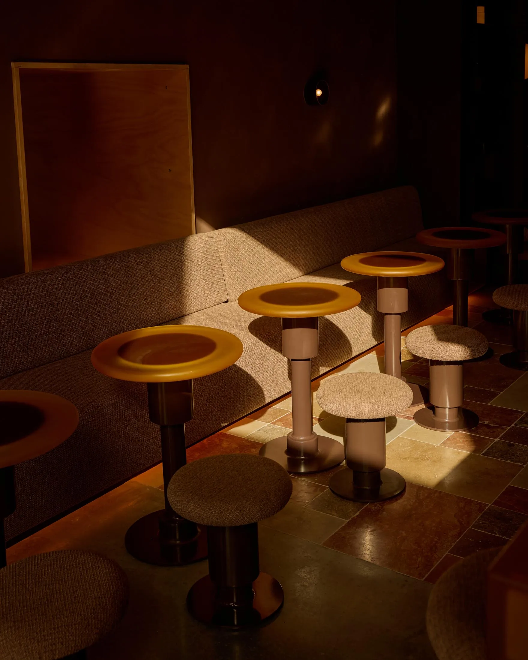 A cozy restaurant interior with multiple dining tables and chairs, creating an inviting atmosphere for socializing and meals