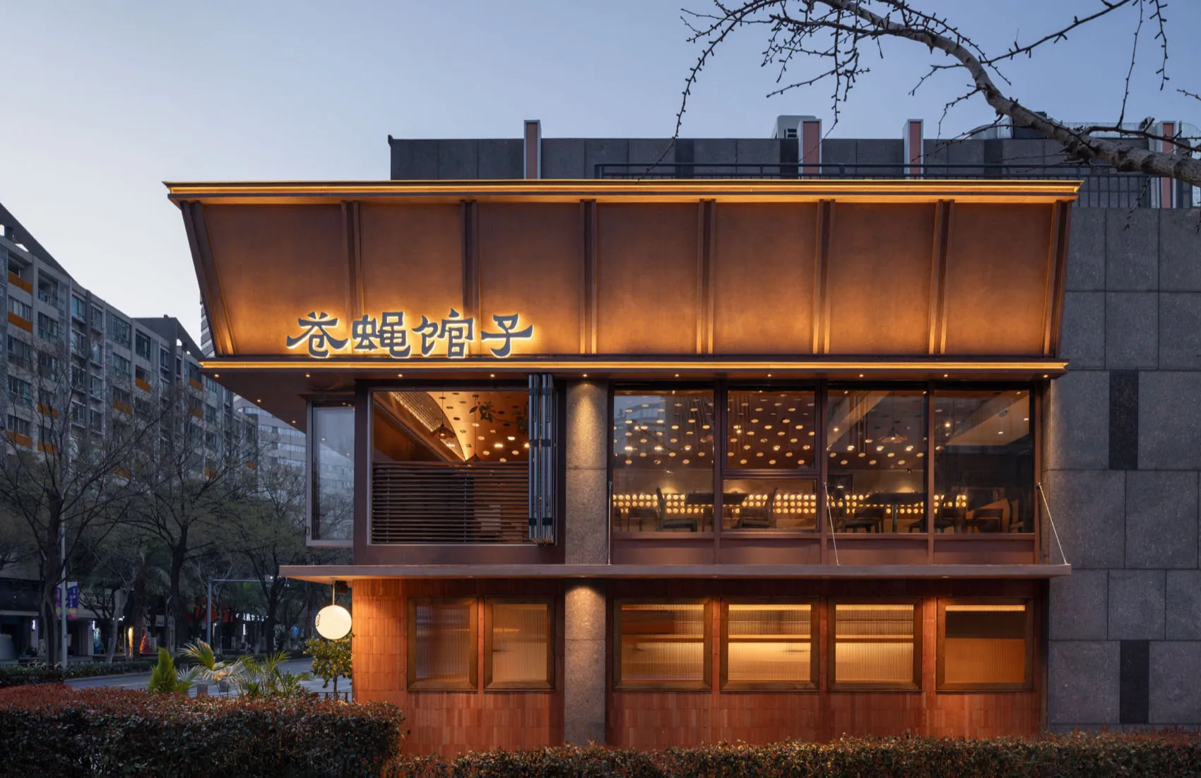 Cozy Asian restaurant with a wooden exterior, stone accents, and a warm atmosphere, featuring dining tables and natural light