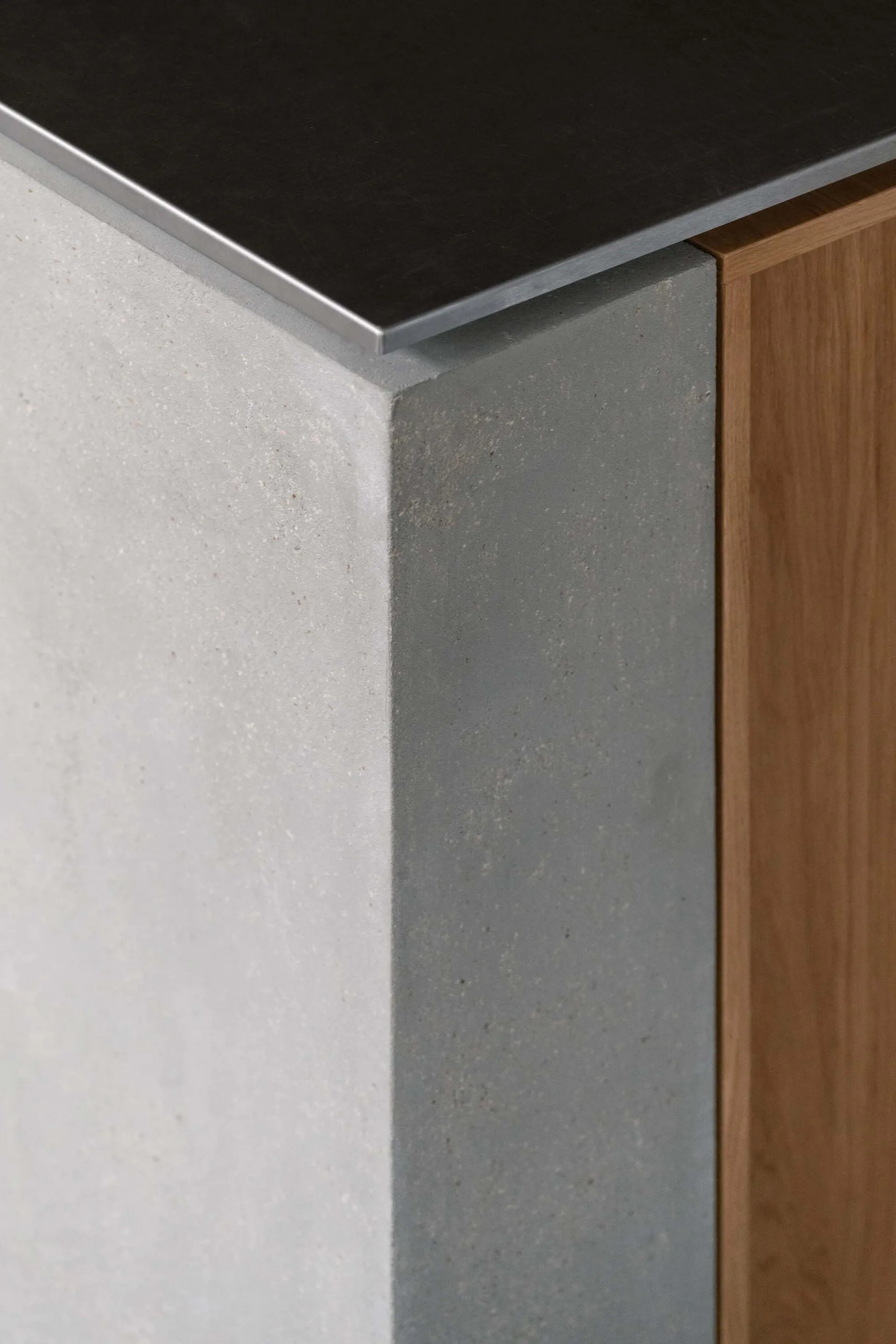 Modern room with concrete and wood walls, metal accents, and a gray and brown color scheme