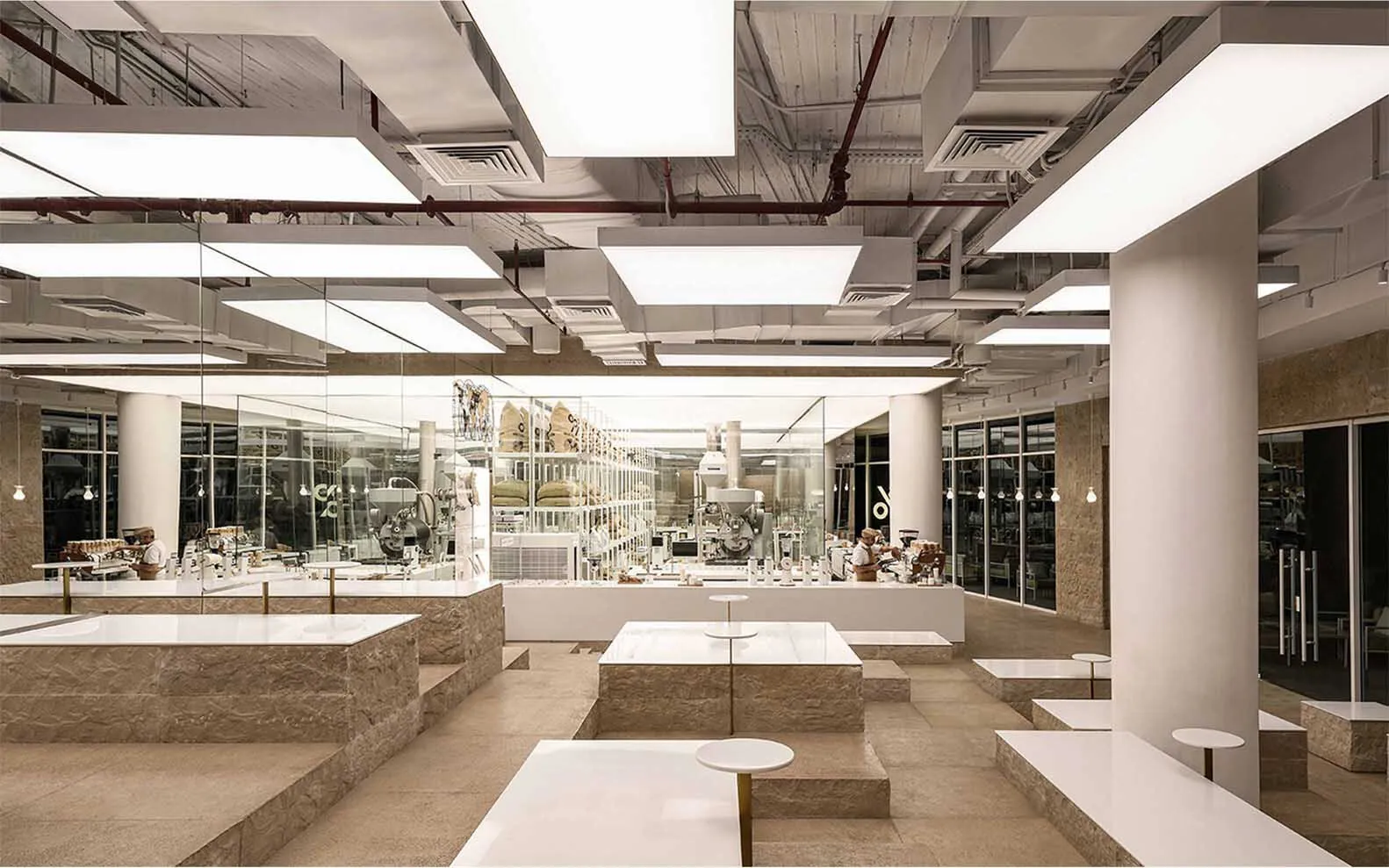 Industrial workspace with tables and bottles, featuring a functional and utilitarian atmosphere with no decorative elements