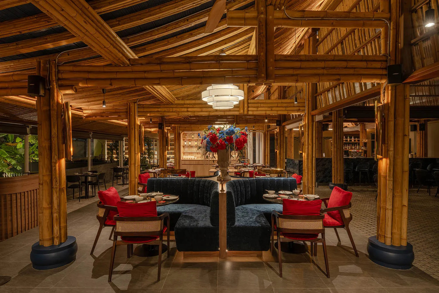 A warm and inviting restaurant interior with wooden elements, bamboo ceiling, multiple dining tables, and chairs