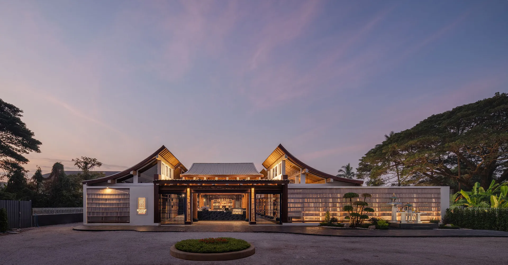 Spacious Asian-style restaurant with wooden structure, potted plants, and a warm atmosphere