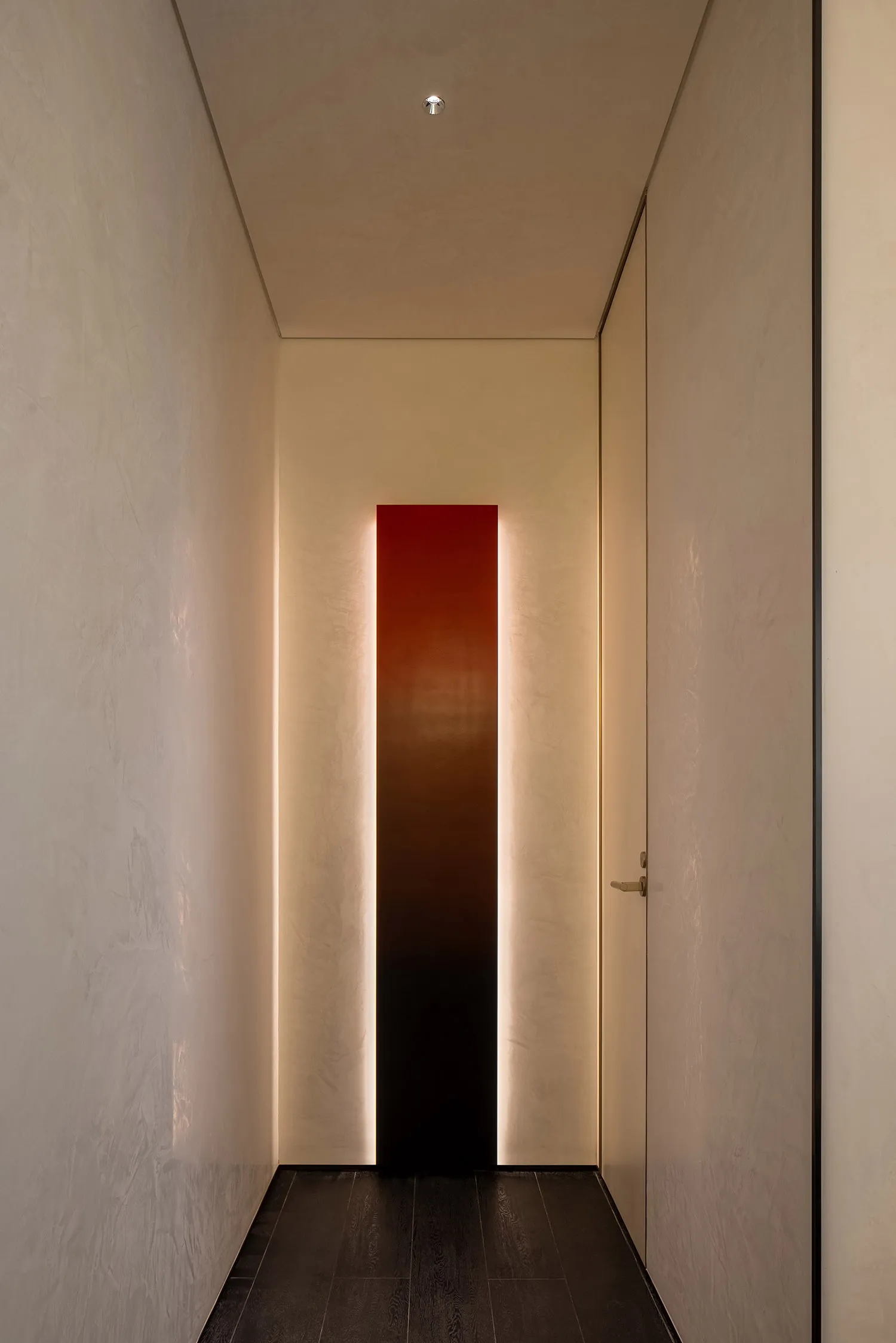 A well-lit hallway with a white wall, two doors, and a red light strip, creating a bright atmosphere