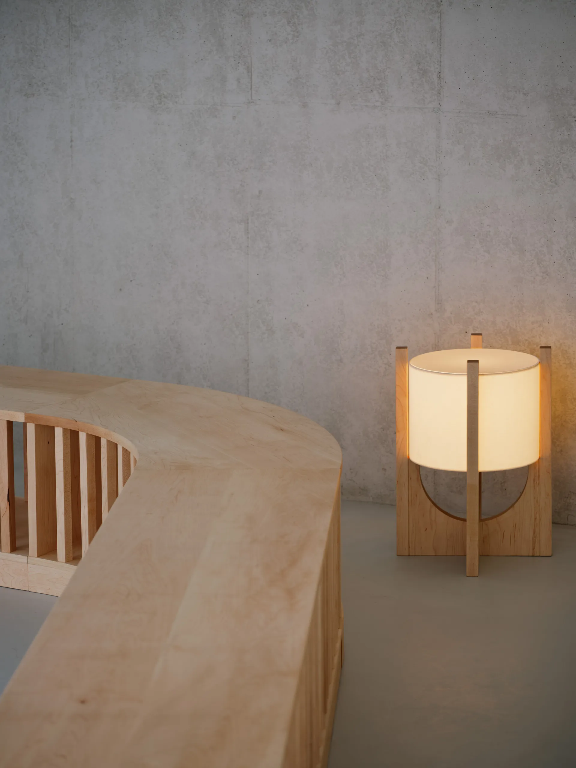 A warm and inviting interior space with a wooden table, two lamps, and a cozy atmosphere