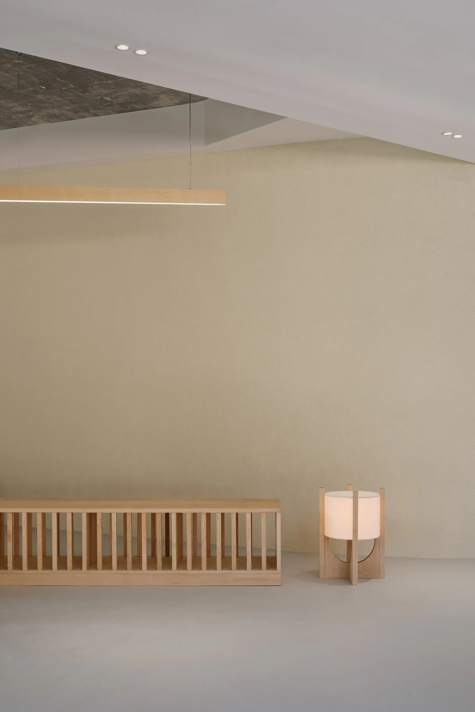 Empty minimalist living space with a wooden bench and two side lights