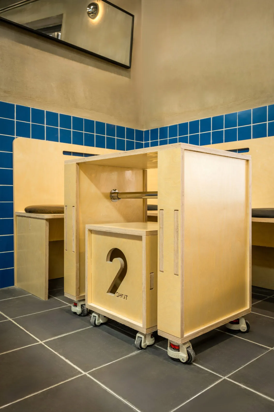 Bathroom with two sinks, wooden cabinets, and tiled walls and floors, featuring a clean and modern appearance