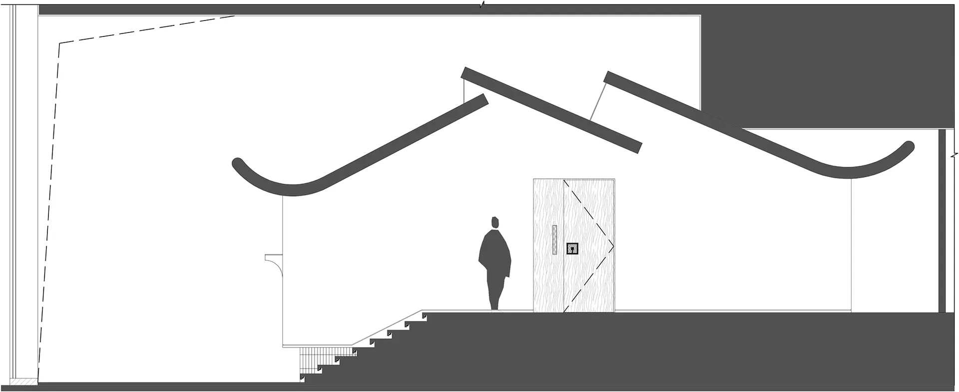 A person stands in front of a doorway looking upwards in a calm and focused residential interior with a staircase in the hallway