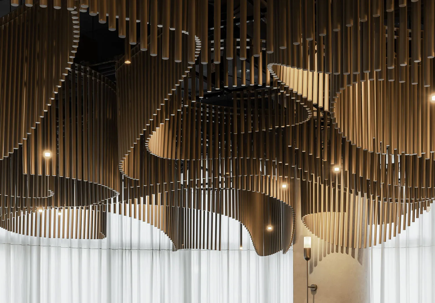 A dimly lit restaurant space with wooden elements, hanging structures, and a cozy atmosphere
