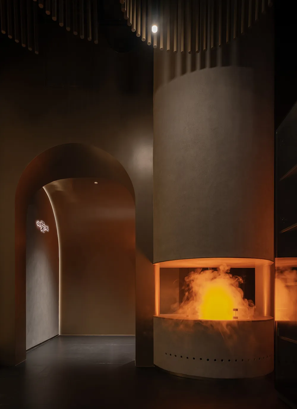 Cozy room with a stone fireplace, smoke billowing out, and a warm atmosphere