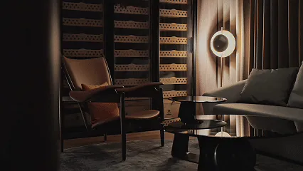 Elegant living space with a dining table, chairs, and a wine rack, featuring a sophisticated atmosphere with a focus on comfort and functionality