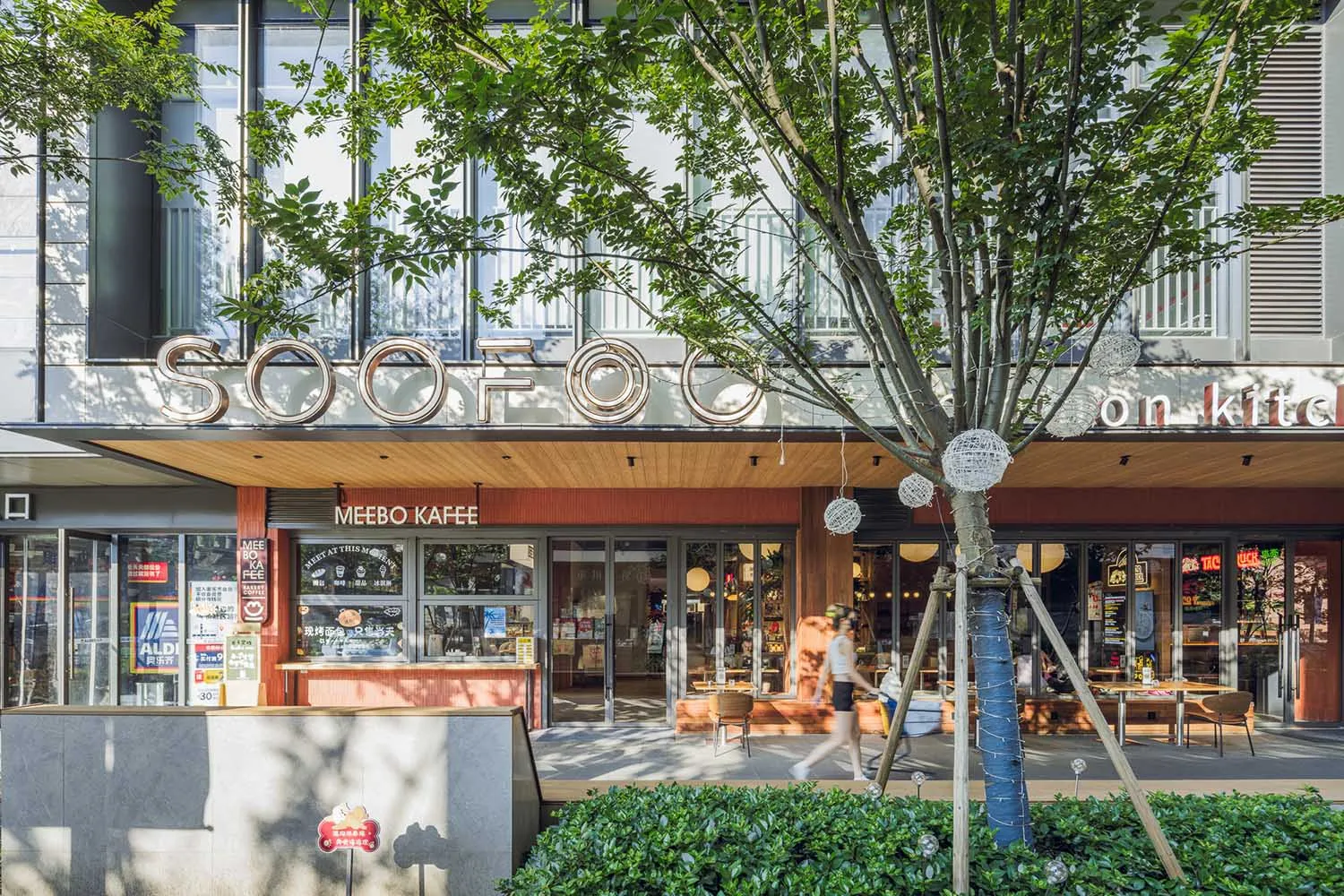 A relaxed outdoor cafe with a wooden facade, chairs, and a dining table, inviting socializing and outdoor seating