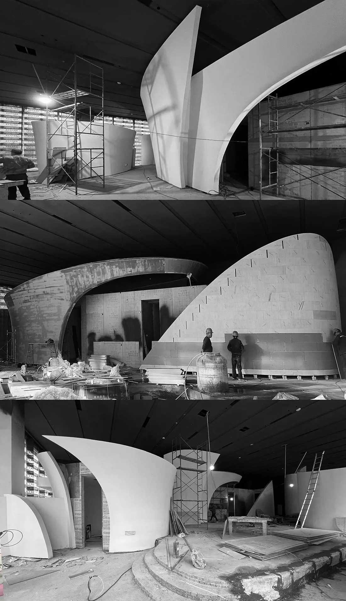 Construction site with workers in various stages of building a structure, with people standing near walls, stairs, and a large structure
