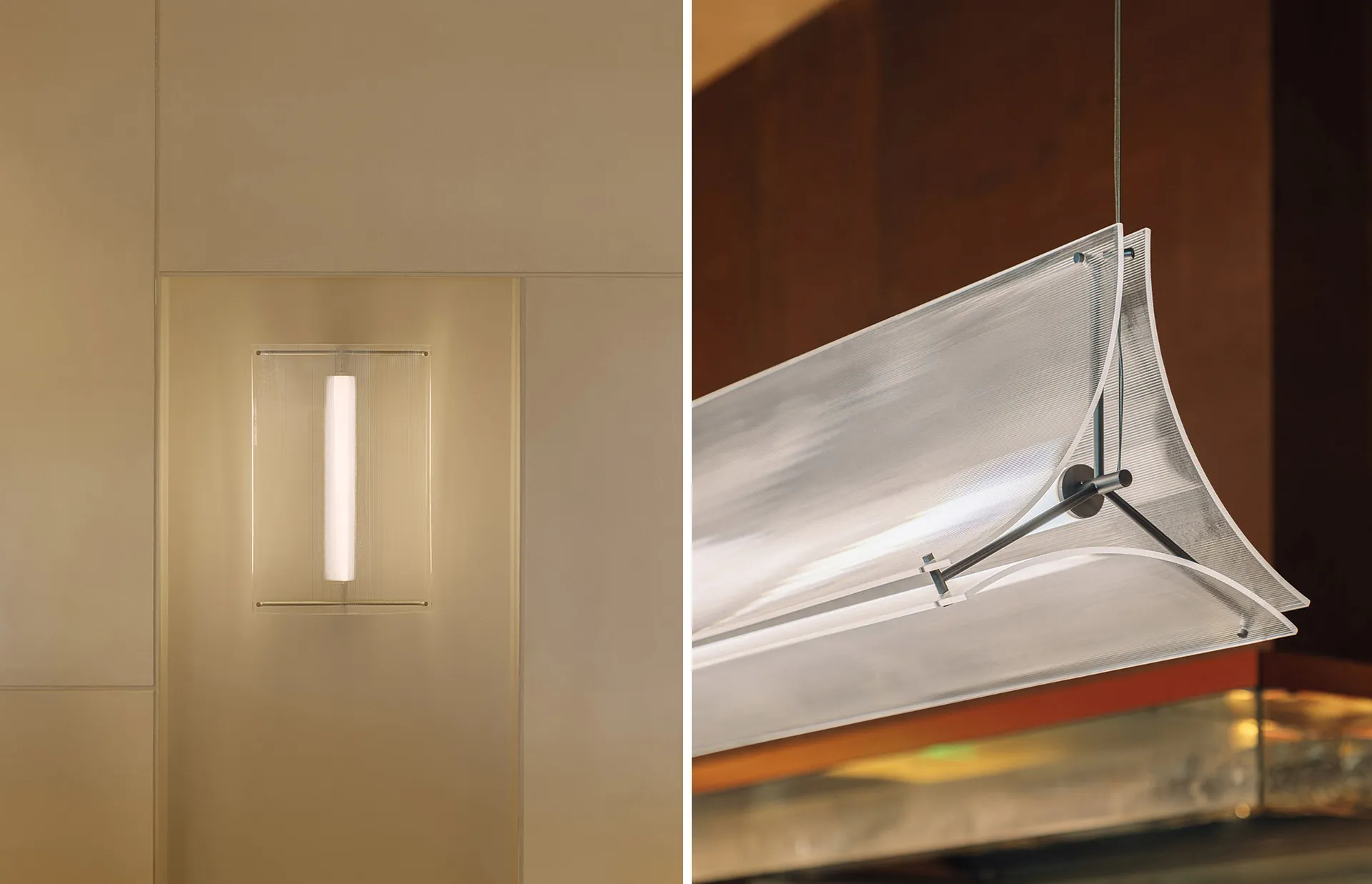 Minimalist interior space with a white wall and a large metal beam, featuring a light fixture and a functional atmosphere