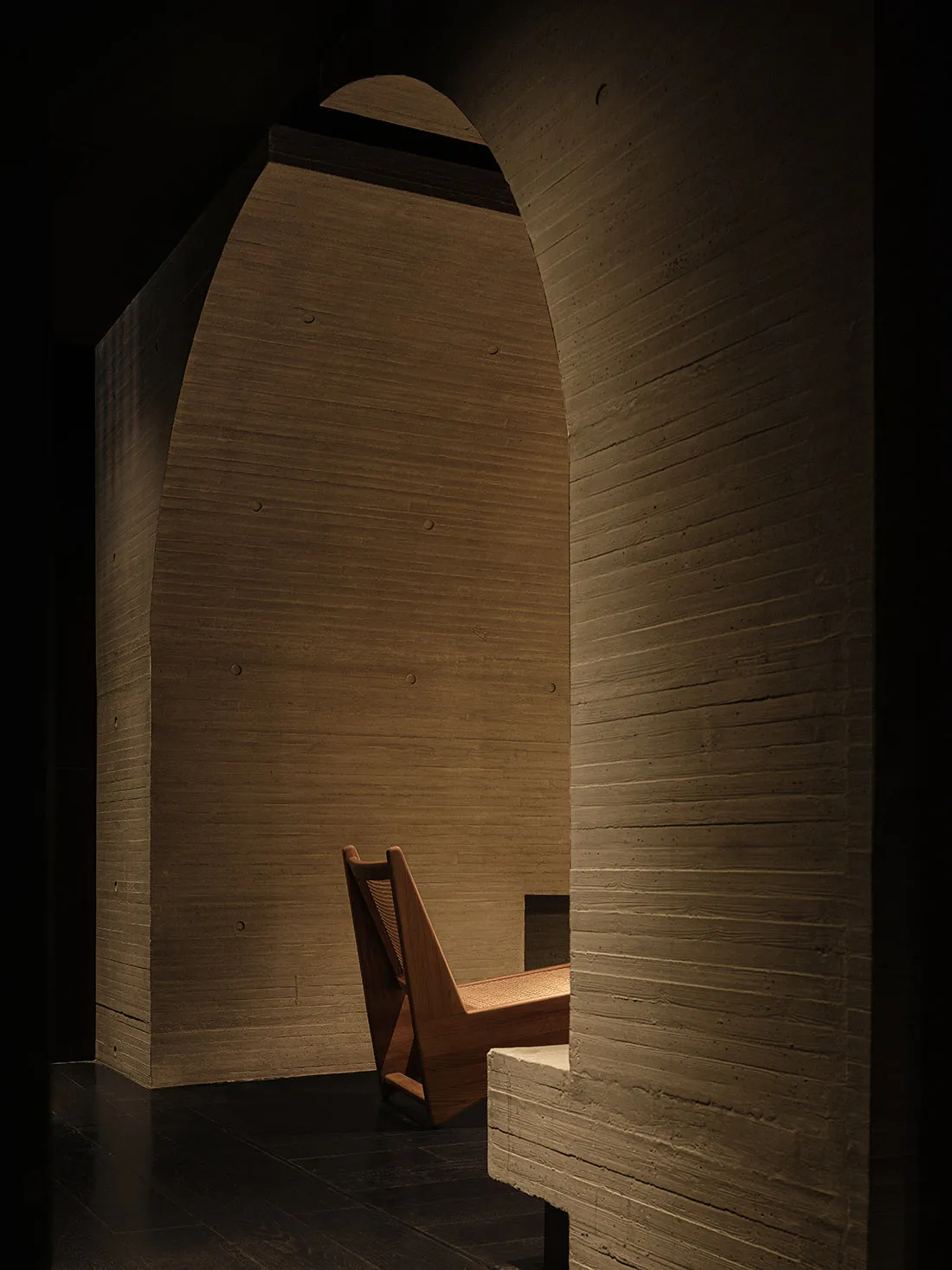 Dimly lit dining room with a wooden chair and dining table, creating a cozy atmosphere