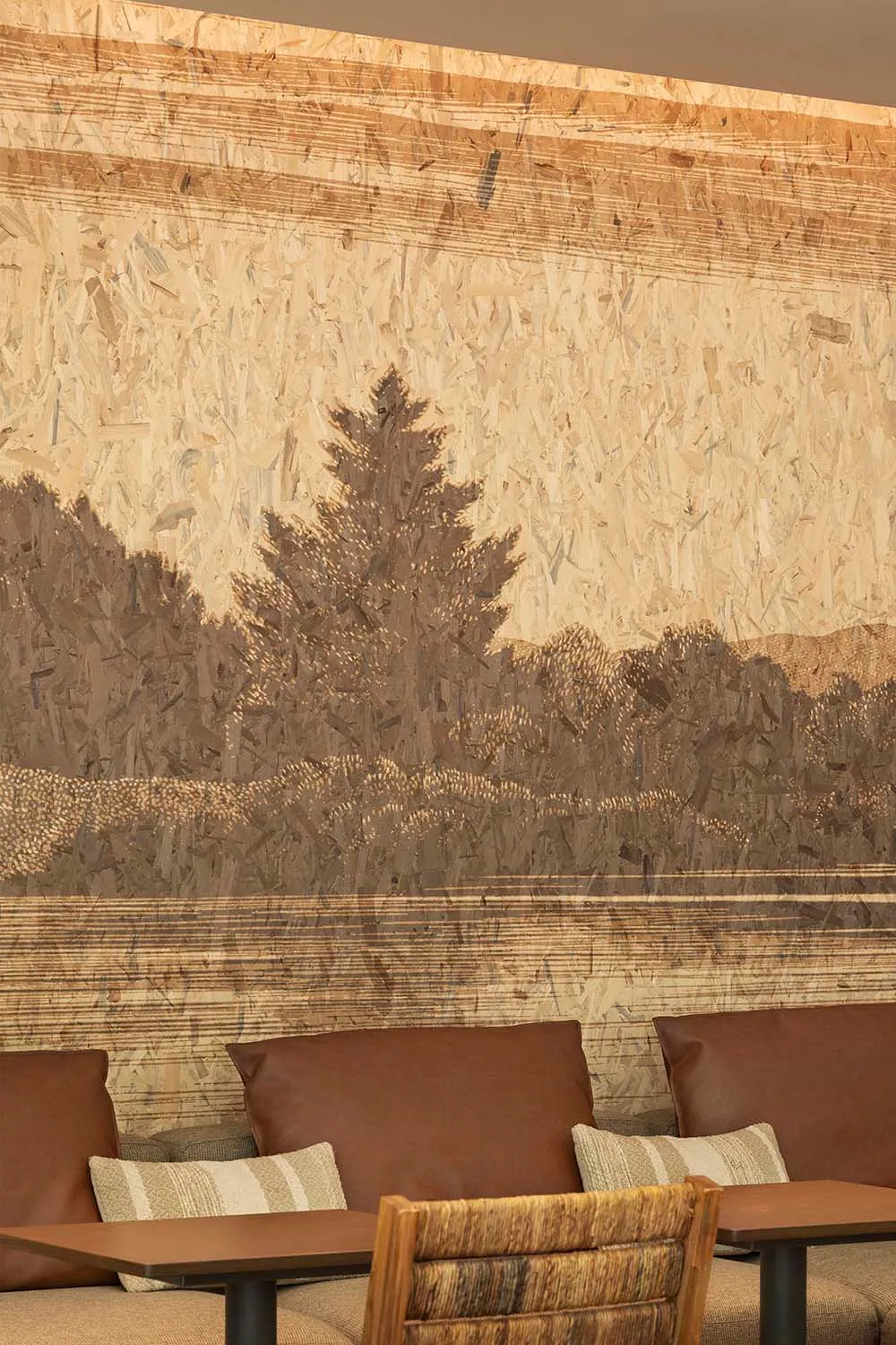 Warm and inviting living room with a tree in the center, featuring three chairs and a cozy atmosphere
