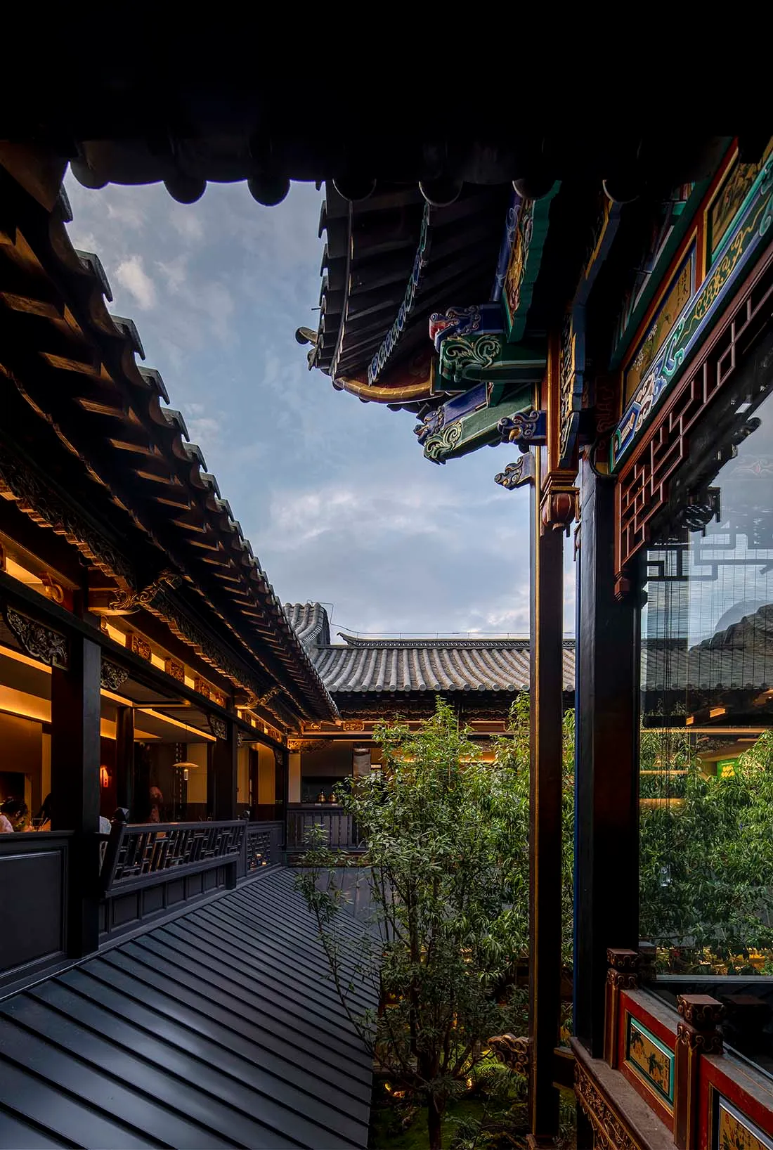 Exterior photo of an Asian-style building with a large roof, multiple windows, and a blend of wood and metal elements