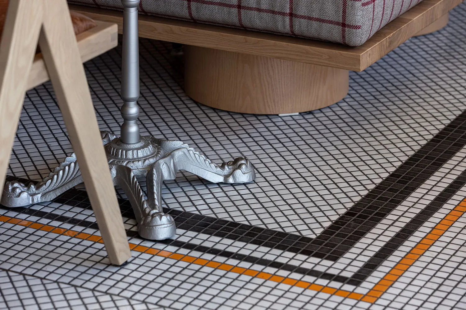 Cozy living space with a checkered tile floor, two chairs, and a dining table, creating a warm and inviting atmosphere