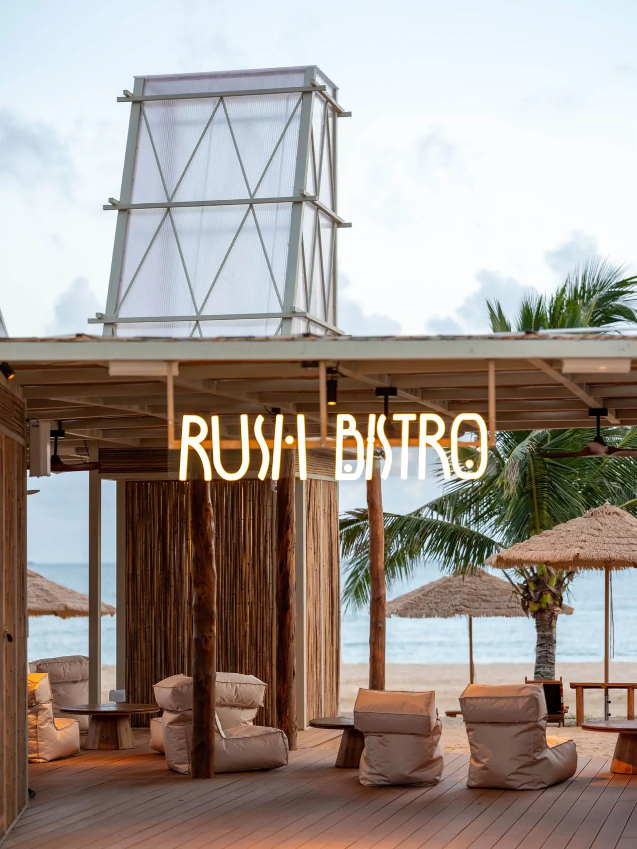 An outdoor patio area with chairs and tables under umbrellas, creating a relaxed and inviting atmosphere for dining or socializing