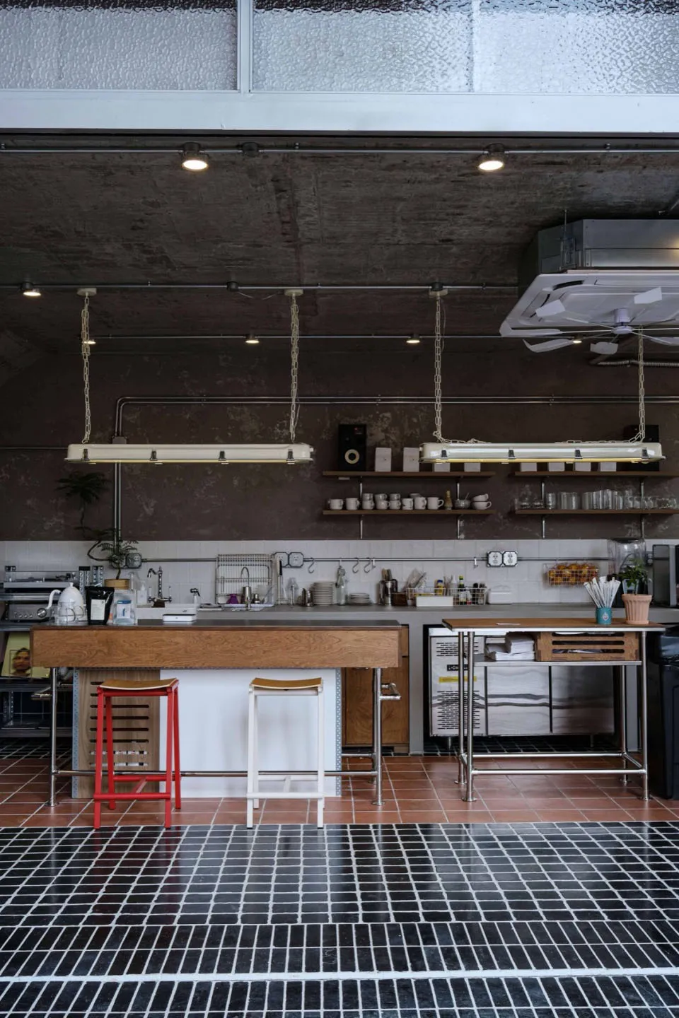 Modern kitchen with wood floors, white cabinets, marble countertops, and various appliances, giving a luxurious and lived-in feel