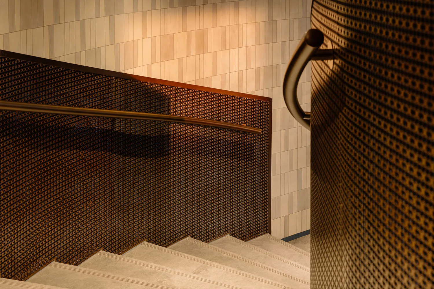 A real staircase in a building with a wooden staircase, a metal object on the right, and a wall in the background, suggesting a functional yet aged design