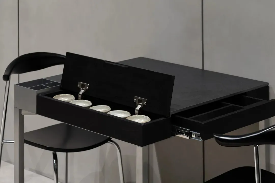A wooden table in a calm and inviting indoor space with white bowls arranged neatly, creating a clean appearance