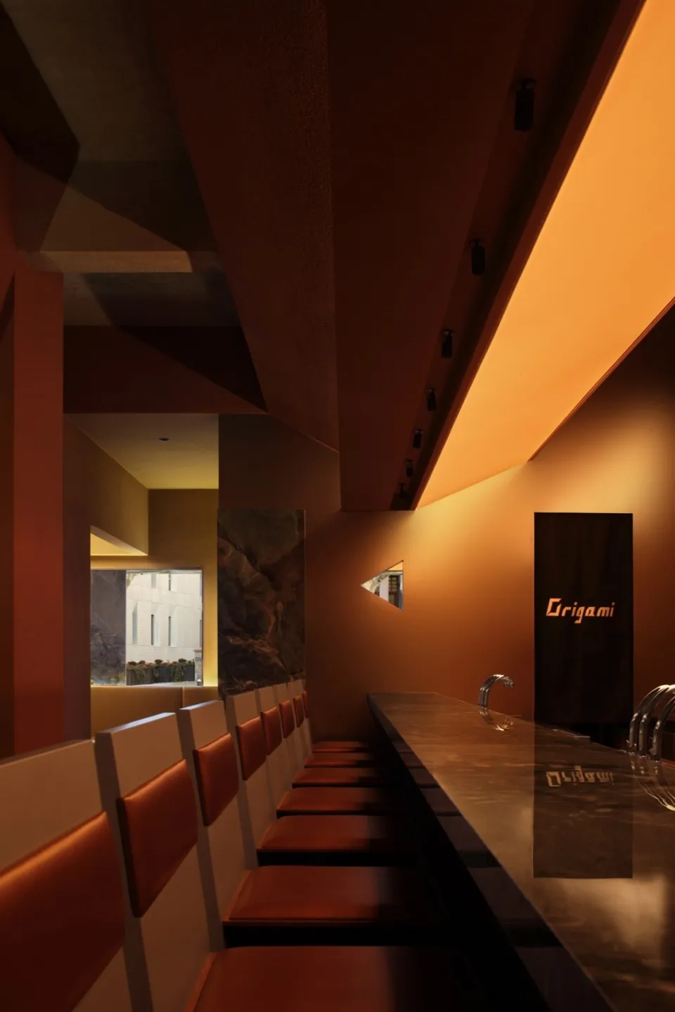 A luxurious dining space with a marble table and comfortable seating for guests, surrounded by sophisticated decor
