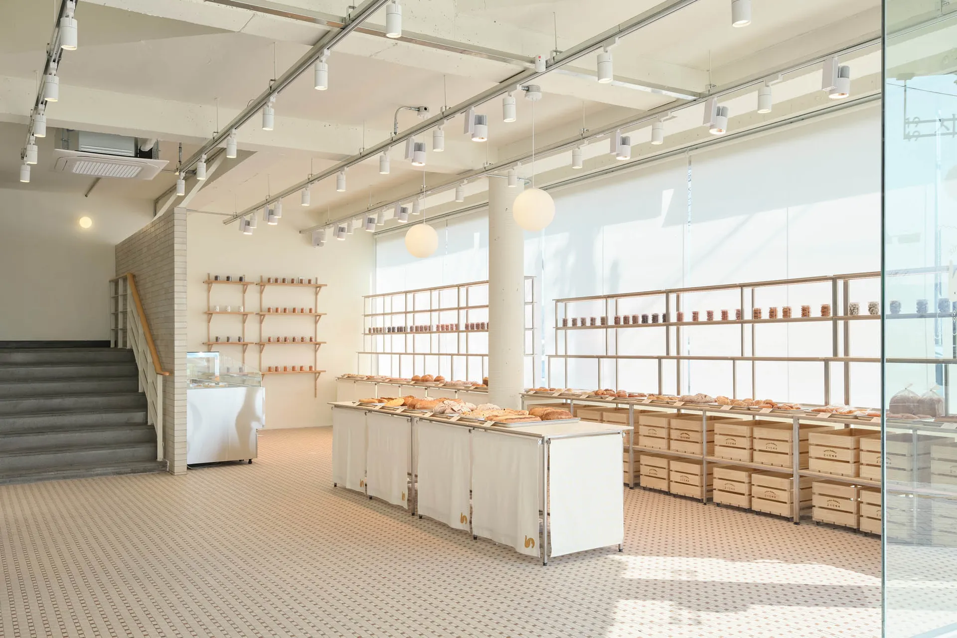 Clean and organized kitchen area with a large countertop featuring various items, bottles, and bowls, with a focus on food preparation and presentation