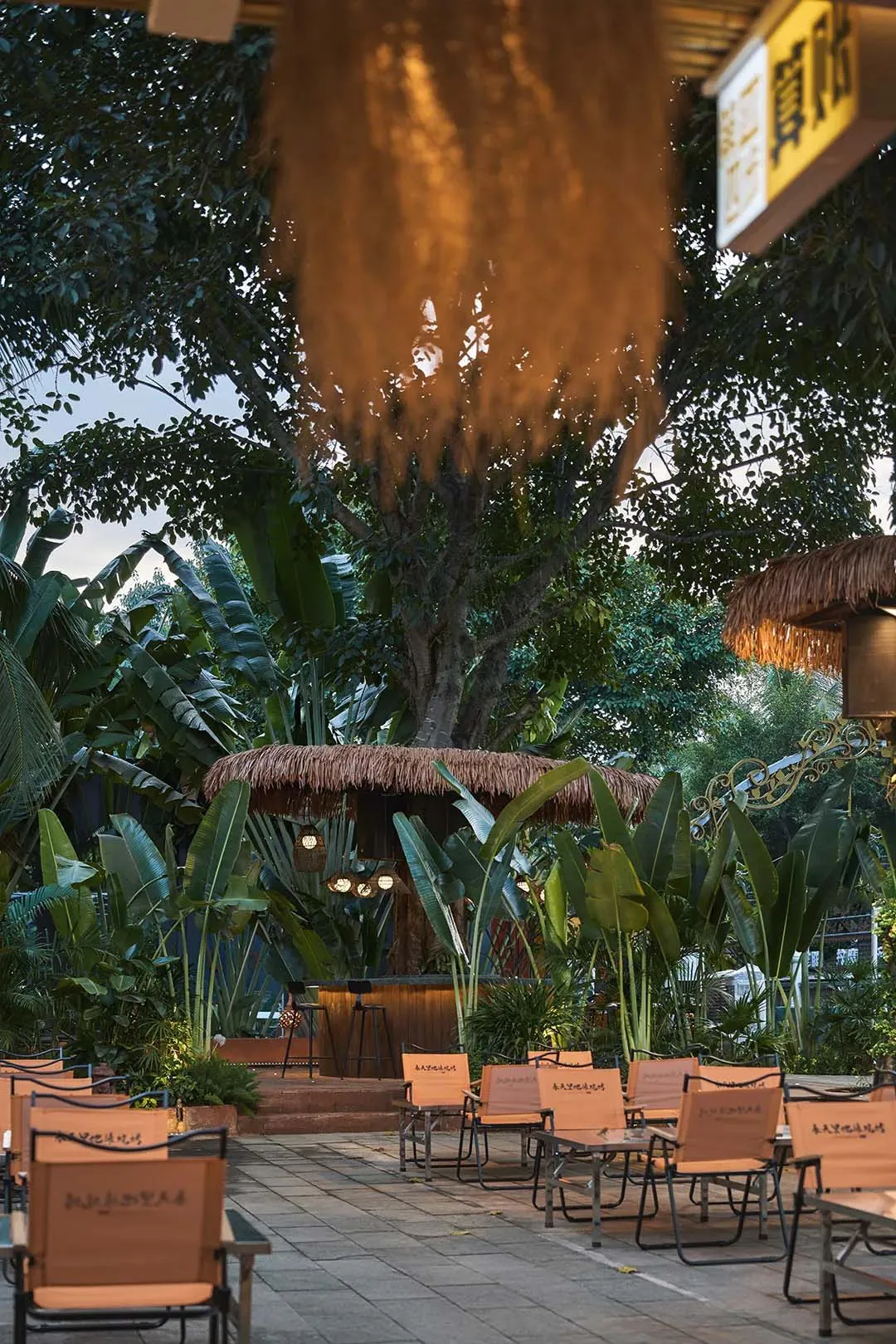 A patio area with wicker chairs arranged around a dining table, set up for socializing and enjoying meals outdoors