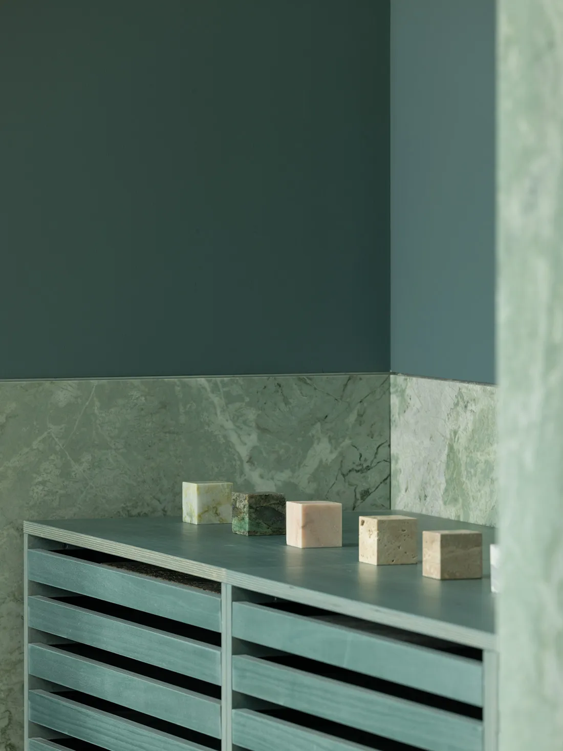 A clean bathroom with a countertop featuring decorative blocks and bottles, showcasing a focus on functionality and aesthetics