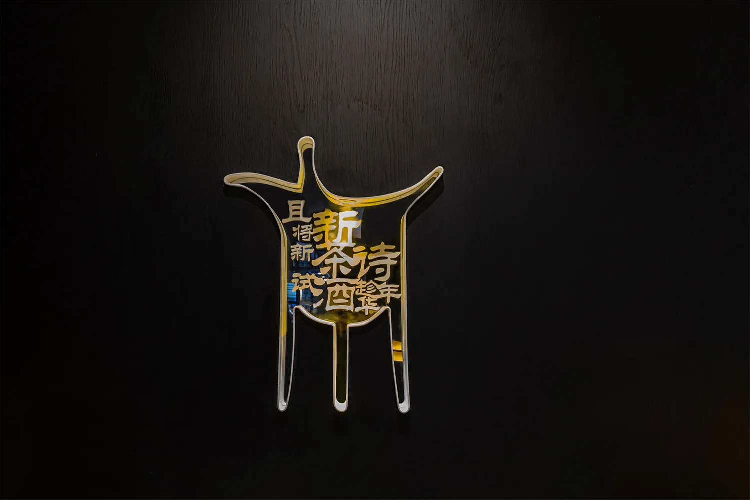 A modern restaurant or establishment features an oriental design on a wall with a yellow and black color scheme, made of glass, and complemented by artistic elements