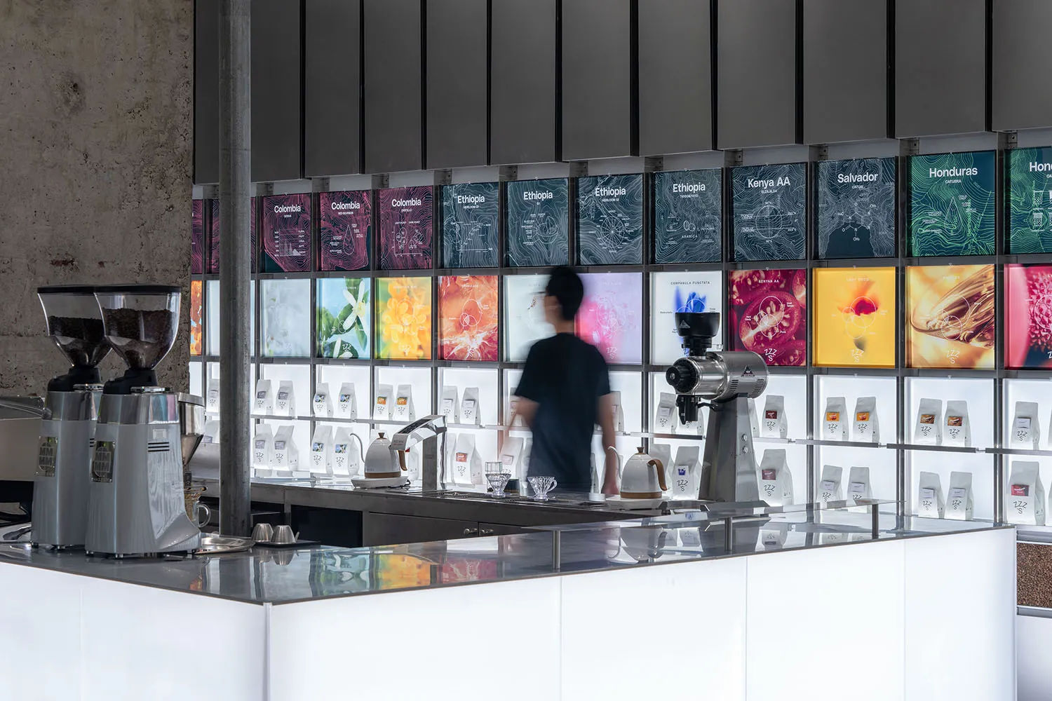 A bustling coffee shop with modern displays, TV screens, and comfortable atmosphere, featuring a counter and various equipment