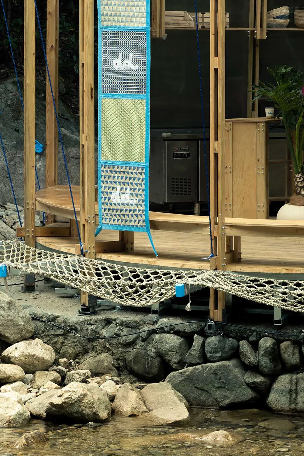 A serene outdoor space with a wooden deck, hammock, and two chairs, perfect for relaxation