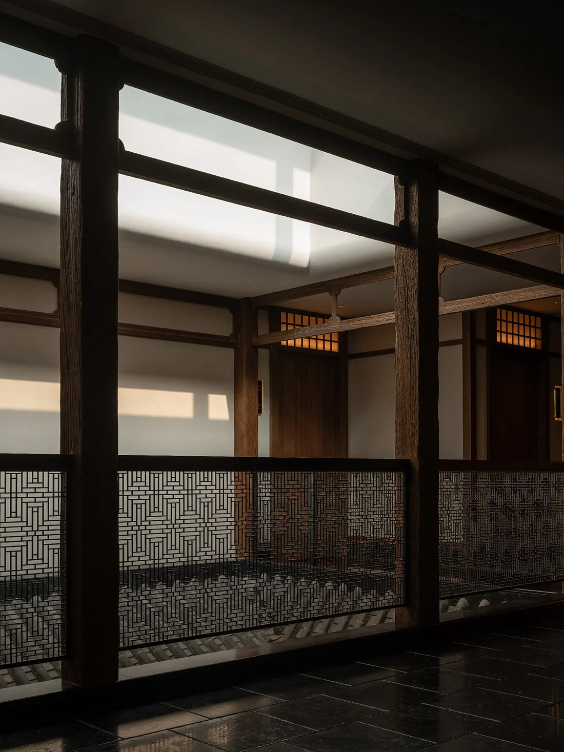 A serene Asian-style hallway with a wooden floor, a staircase, and a bench, set against a backdrop of elegant architecture