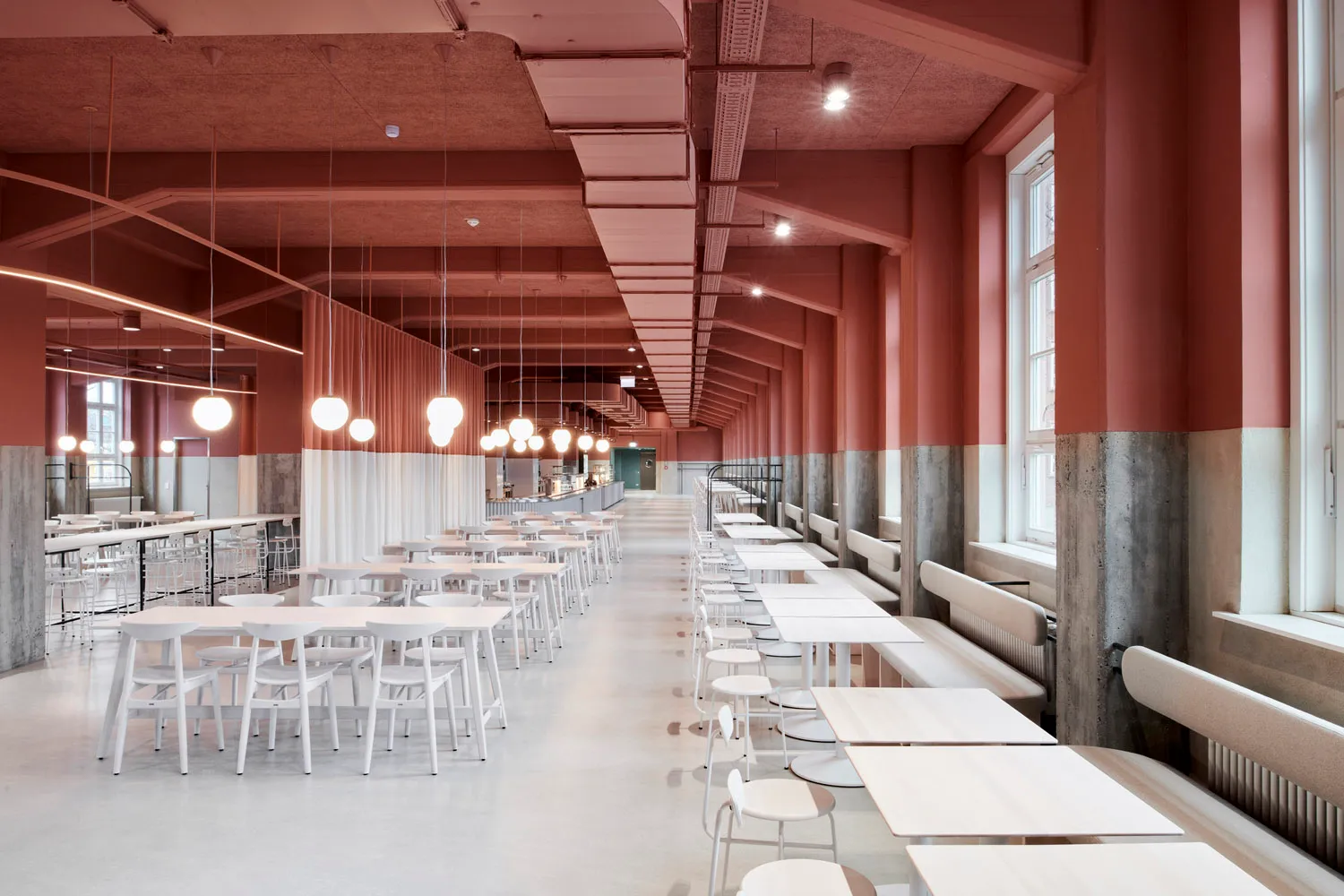 Modern dining area with white tables and chairs, well-lit and inviting