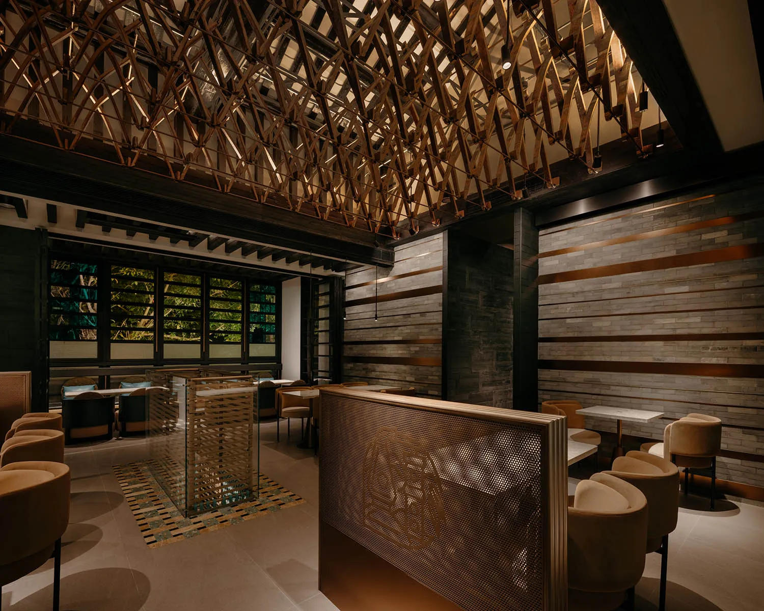 Cozy restaurant interior with wooden walls and ceiling, dim lighting, and dining tables with chairs