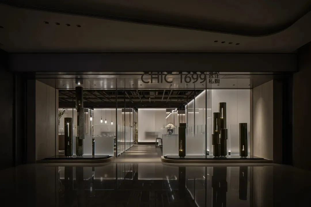 A well-lit modern commercial space with a large glass window, potted plants, and a clean atmosphere