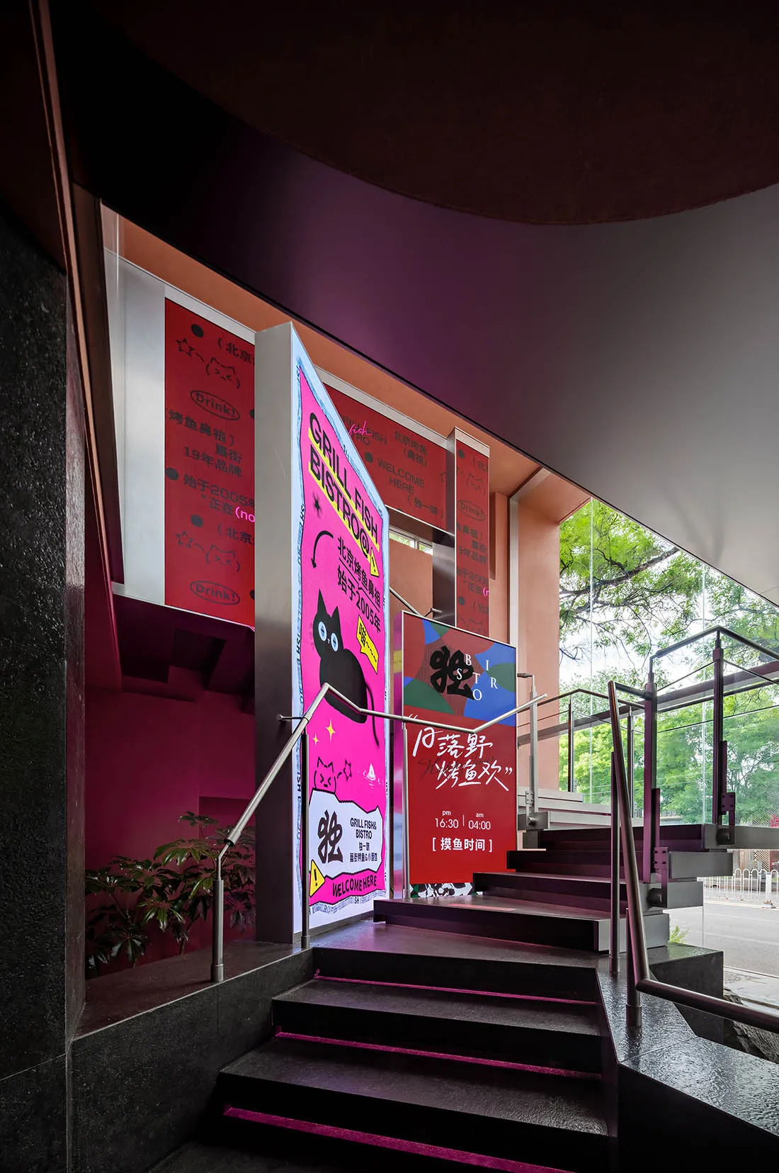 Modern hotel lobby with pink walls, a staircase, and signs including one reading Golden Cat, with a cat present in the scene