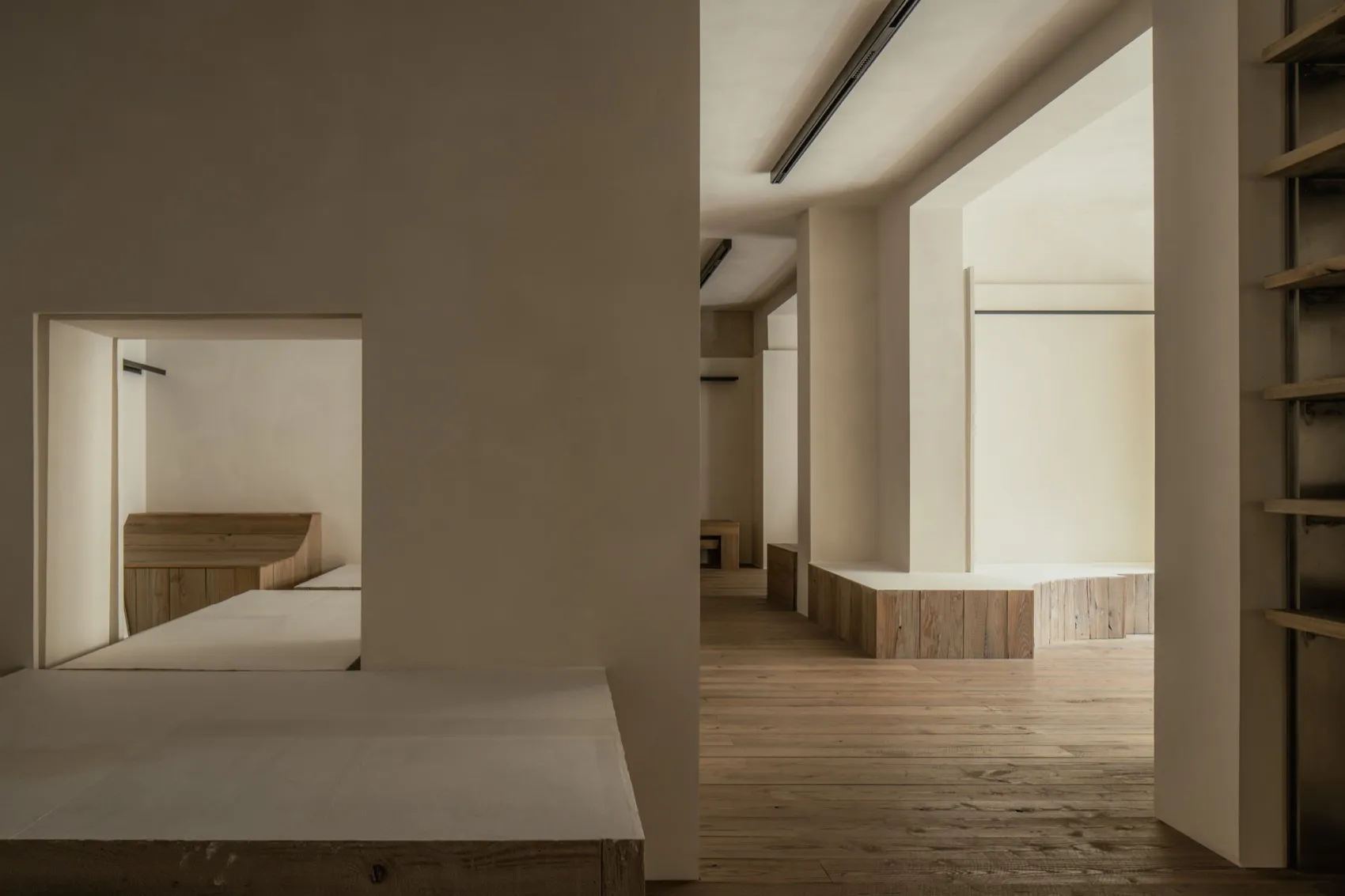 Empty room with wooden floors and walls, showcasing clean lines and minimalist aesthetic